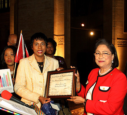 Invest Caribbean Now Founder/Chairman Felicia Persaud, l, presents a certificate of appreciation to Trinidad & Tobago Prime Minister Kamla Persad-Bissessar as ICN President Sheila Newton-Moses, far left, looks on. (Hayden Roger Celestin image)